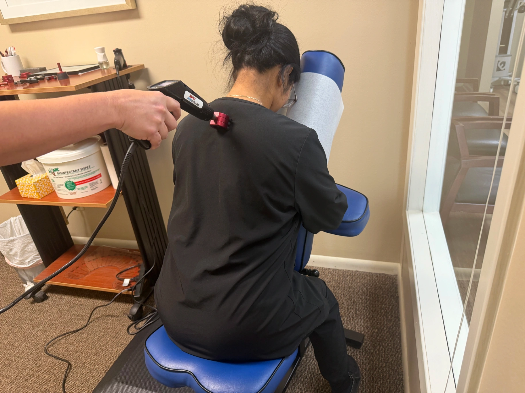 Dr. Faulkenberry delivering a ProAdjuster adjustment to a patient at Faulkenberry Chiropractic in Little Rock