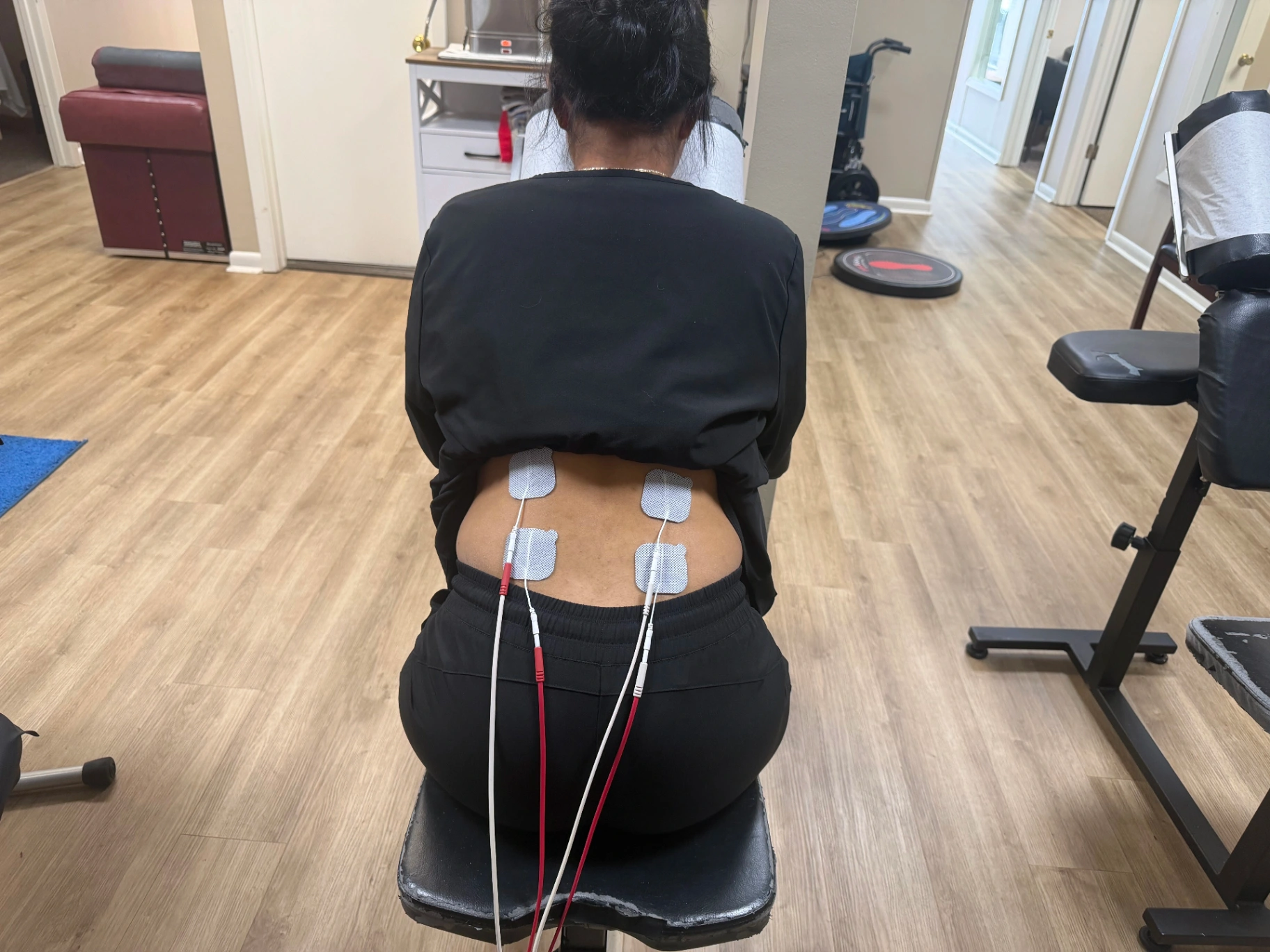 Patient receiving electrical stimulation therapy on the lower back at Faulkenberry Chiropractic in Little Rock