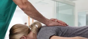 Chiropractor performing a spinal adjustment on a patient to improve alignment and reduce back pain